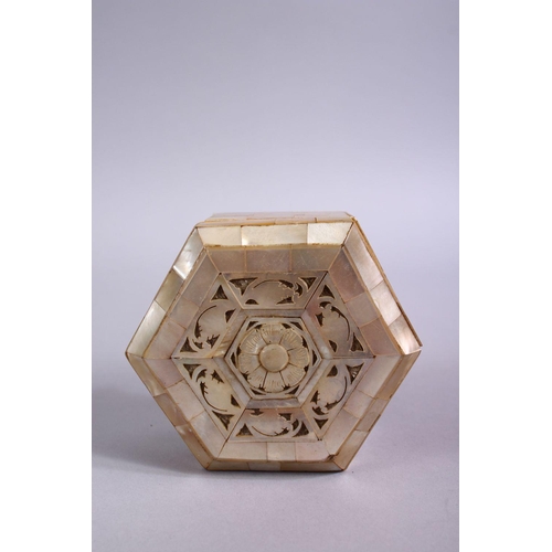 816 - A 19TH CENTURY INDIAN MOTHER OF PEARL LIDDED BOX, the top with carved foliate design, 8cm wide.