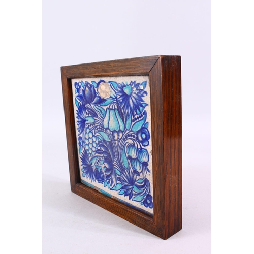 835 - A GOOD FRAMED TURKISH POTTERY TILE, decorated with two tone blue fruit and vine decoration, 23cm squ... 