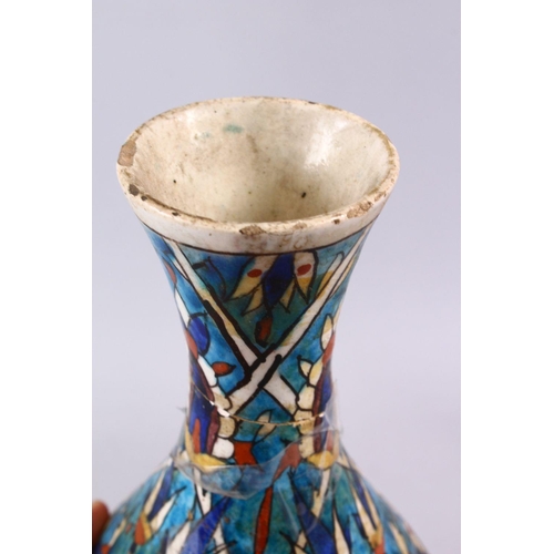 836 - AN EARLY PERSIAN POTTERY BOTTLE VASE, with formal floral motif, 30cm, (AF)