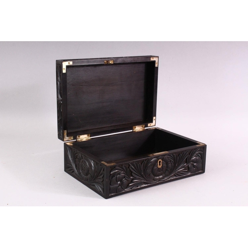 848 - A CEYLONESE CARVED EBONY CASKET, with hinged lid, 26cm long.