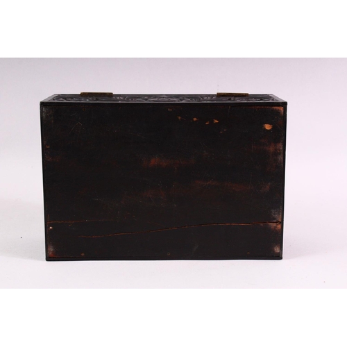 848 - A CEYLONESE CARVED EBONY CASKET, with hinged lid, 26cm long.