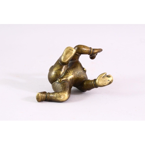 850 - A SMALL EARLY CAST BRONZE INDIAN CROUCHING FIGURE, with inset gold and ruby eyes, 9cm long.