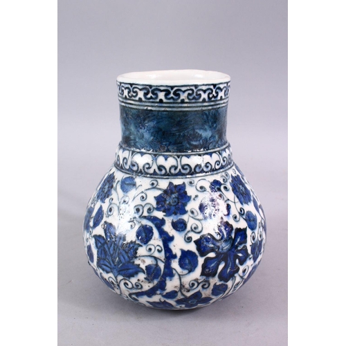 856 - AN ISLAMIC BLUE & WHITE PORCELAIN WATER JUG, decorated ith formal scrolling flora, 20cm high.