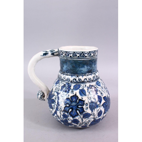 856 - AN ISLAMIC BLUE & WHITE PORCELAIN WATER JUG, decorated ith formal scrolling flora, 20cm high.