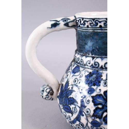 856 - AN ISLAMIC BLUE & WHITE PORCELAIN WATER JUG, decorated ith formal scrolling flora, 20cm high.