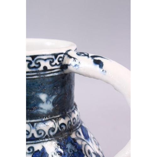 856 - AN ISLAMIC BLUE & WHITE PORCELAIN WATER JUG, decorated ith formal scrolling flora, 20cm high.