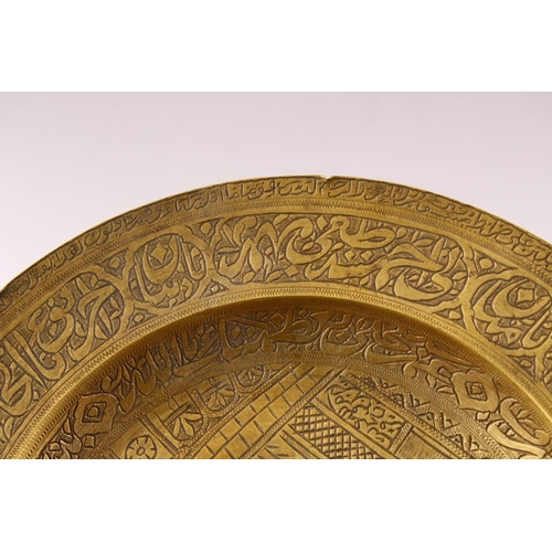 858 - A 19TH CENTURY PERSIAN ENGRAVED CALLIGRAPHIC BRASS DISH, with bands of calligraphy and temple scenes... 