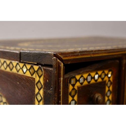 862 - A GOOD 19TH CENTURY INDIAN WOODEN BOX, with six drawers and band of inlaid mother of pearl, 34cm wid... 