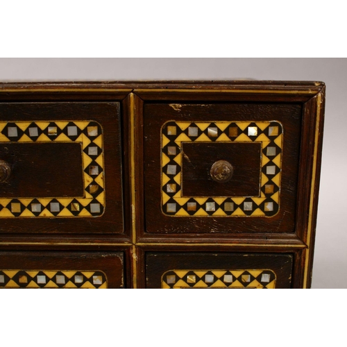 862 - A GOOD 19TH CENTURY INDIAN WOODEN BOX, with six drawers and band of inlaid mother of pearl, 34cm wid... 