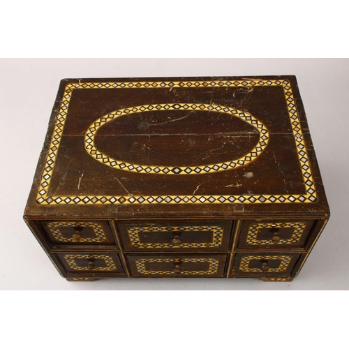 862 - A GOOD 19TH CENTURY INDIAN WOODEN BOX, with six drawers and band of inlaid mother of pearl, 34cm wid... 