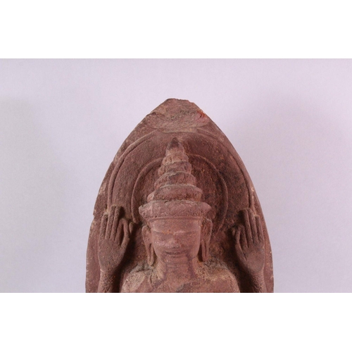 865 - A 12TH CENTURY STYLE CAMBODIAN KHMER STYLE RED SANDSTONE CARVING OF A FOUR ARMED DEITY. 52cms high.... 