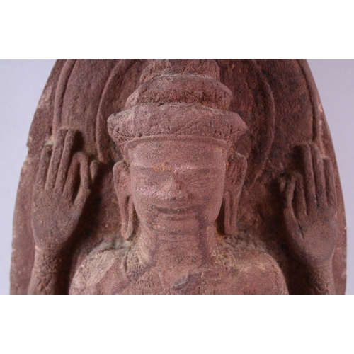 865 - A 12TH CENTURY STYLE CAMBODIAN KHMER STYLE RED SANDSTONE CARVING OF A FOUR ARMED DEITY. 52cms high.... 