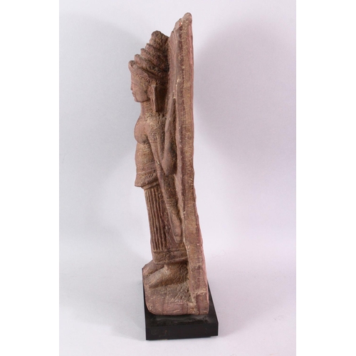 865 - A 12TH CENTURY STYLE CAMBODIAN KHMER STYLE RED SANDSTONE CARVING OF A FOUR ARMED DEITY. 52cms high.... 