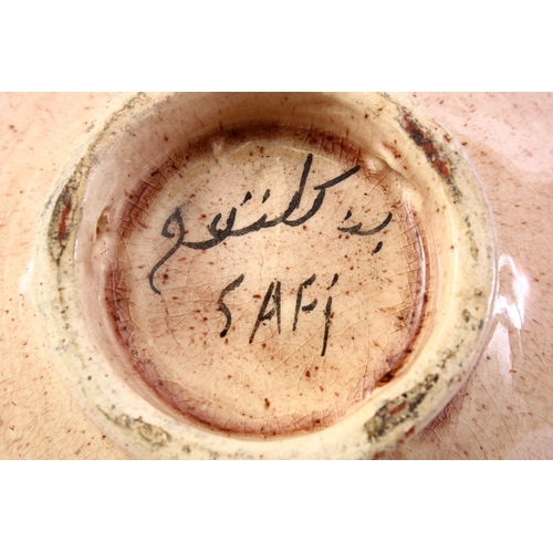 867 - A GOOD ISLAMIC SIGNED POTTERY BOWL - SAFI, the interior decorated with formal floral design, the bas... 