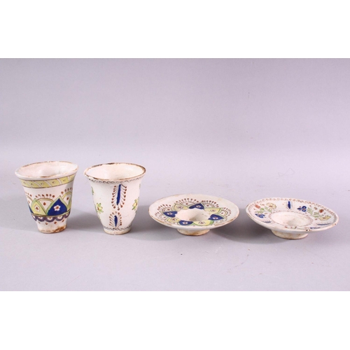 884 - TWO ISLAMIC POTTERY CUPS AND SAUCERS, with floral and geometric decoration.