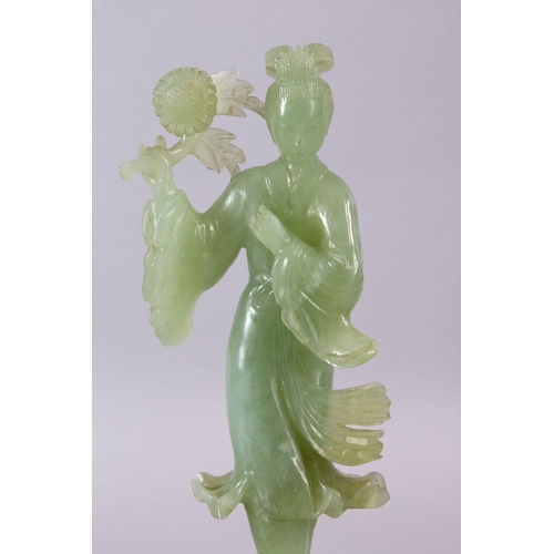 90 - A CHINESE CARVED JADE FIGURE OF GUANYIN, stood holding a bouquet above her head, on a wooden stand, ... 