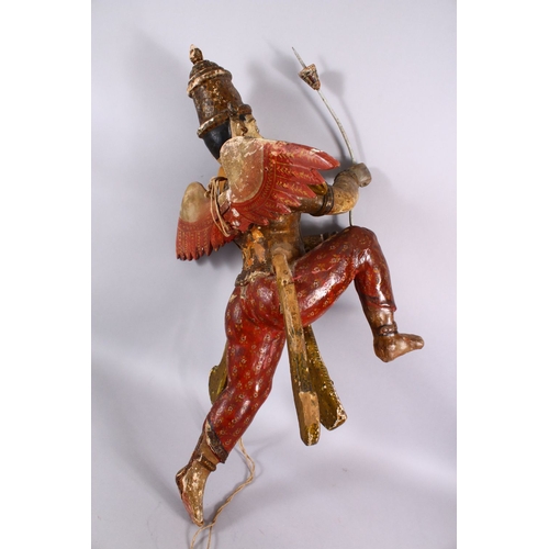 825 - A 19TH CENTURY INDIAN / BURMESE CARVED WOOD FIGURE OF A WINGED GOD, stood holding an implement, with... 