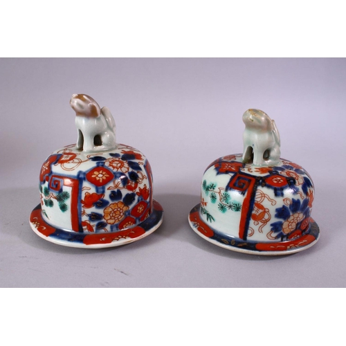 1 - A PAIR OF MEIJI PERIOD IMARI VASES AND COVERS, with kylin finials, overall 30cm high.