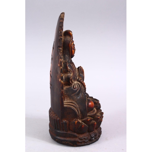 102 - A GOOD CHINESE CARVED IVORY STYLE FIGURE OF SEATED GUANYIN, seated upon a lotus base, with her hands... 