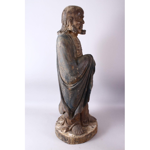 11 - A 18TH/19TH CENTURY CHINESE CARVED WOOD FIGURE OF ROHAN, on a shaped base, 90cm high.