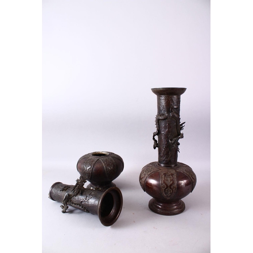 12 - A PAIR OF 18TH CENTURY JAPANESE BRONZE VASES, bulbous shaped and tapering tops with dragons in relie... 