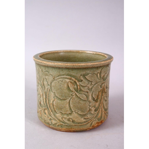 121 - A CHINESE LONGQUAN CELEDON CARVED POTTERY BRUSH WASH, carved with stylised flora, 8.5cm high, 10cm d... 