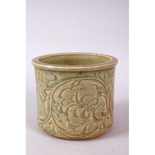 121 - A CHINESE LONGQUAN CELEDON CARVED POTTERY BRUSH WASH, carved with stylised flora, 8.5cm high, 10cm d... 