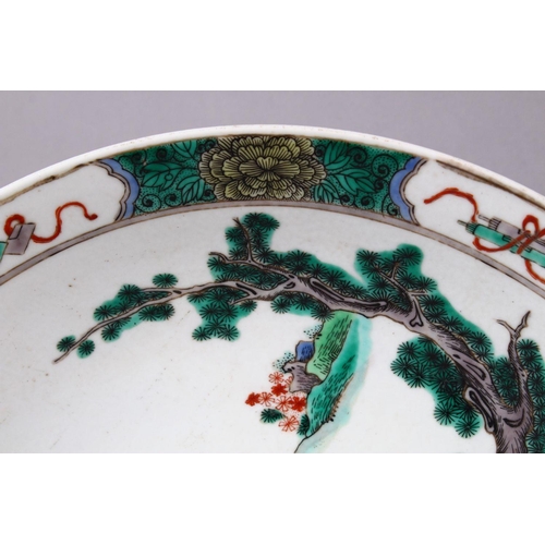 127 - A DECORATIVE 20TH CENTURY FAMILLE VERTE PORCELAIN DISH IN KANGXI STYLE, painted with females in a la... 