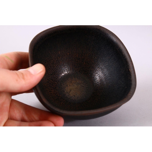 133 - A CHINESE JIANWARE TEA BOWL, with dark brown drip glazed decoration, 11cm diameter.