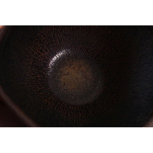 133 - A CHINESE JIANWARE TEA BOWL, with dark brown drip glazed decoration, 11cm diameter.