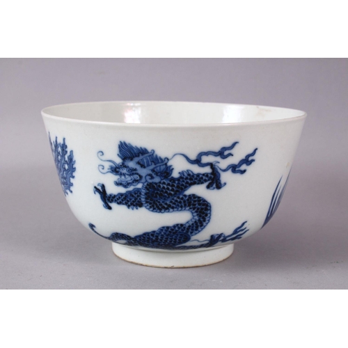 134 - A CHINESE BLUE AND WHITE PORCELAIN BOWL, painted with phoenix and dragons, the base with Kangxi mark... 