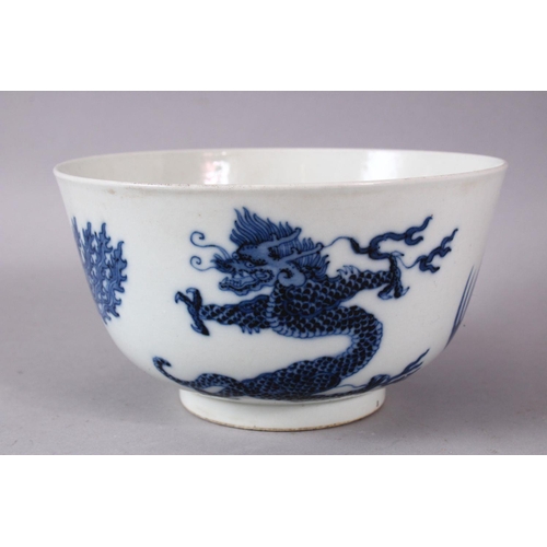 134 - A CHINESE BLUE AND WHITE PORCELAIN BOWL, painted with phoenix and dragons, the base with Kangxi mark... 