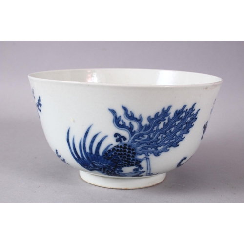 134 - A CHINESE BLUE AND WHITE PORCELAIN BOWL, painted with phoenix and dragons, the base with Kangxi mark... 