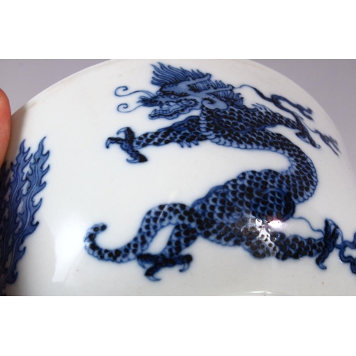 134 - A CHINESE BLUE AND WHITE PORCELAIN BOWL, painted with phoenix and dragons, the base with Kangxi mark... 