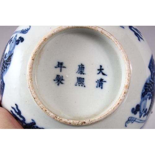 134 - A CHINESE BLUE AND WHITE PORCELAIN BOWL, painted with phoenix and dragons, the base with Kangxi mark... 