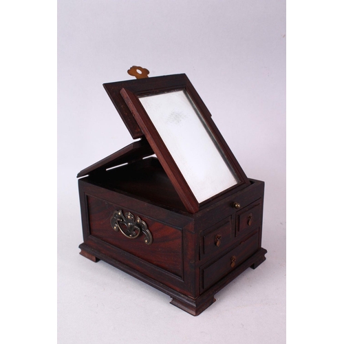 137 - A CHINESE HARDWOOD SMALL DRESSING TABLE BOX, with folding mirror and three small drawers, 17cm deep,... 