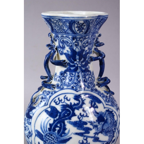 141 - A SMALL CHINESE BLUE AND WHITE PORCELAIN VASE, the neck with moulded animal form handles, the body d... 