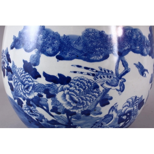 142 - A CHINESE BLUE AND WHITE JARDINIERE, painted with birds amongst native flora, 23cm high, 28cm diamet... 