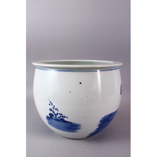 142 - A CHINESE BLUE AND WHITE JARDINIERE, painted with birds amongst native flora, 23cm high, 28cm diamet... 