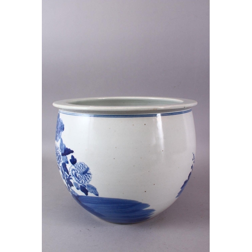 142 - A CHINESE BLUE AND WHITE JARDINIERE, painted with birds amongst native flora, 23cm high, 28cm diamet... 