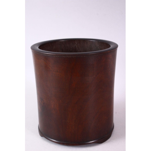 143 - A CHINESE BURR WOOD BRUSH POT, of plain design, on three bracket feet, 16cm high.