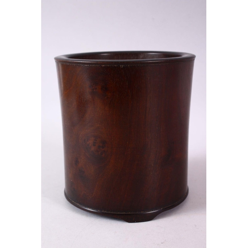 143 - A CHINESE BURR WOOD BRUSH POT, of plain design, on three bracket feet, 16cm high.