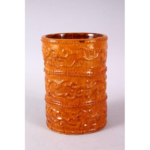 144 - A SMALL UNUSUAL CHINESE SIMULATED BAMBOO MOULDED POTTERY BRUSH POT, decorated with three bands of ph... 