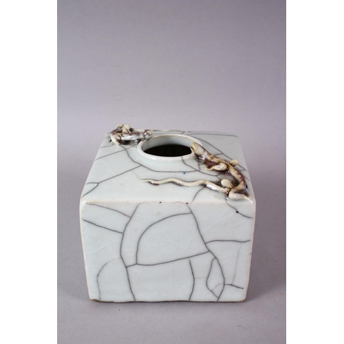 145 - A CHINESE CRACKLE GLAZE SQUARE FORM BRUSH POT, with moulded with chilong, 12cm wide.