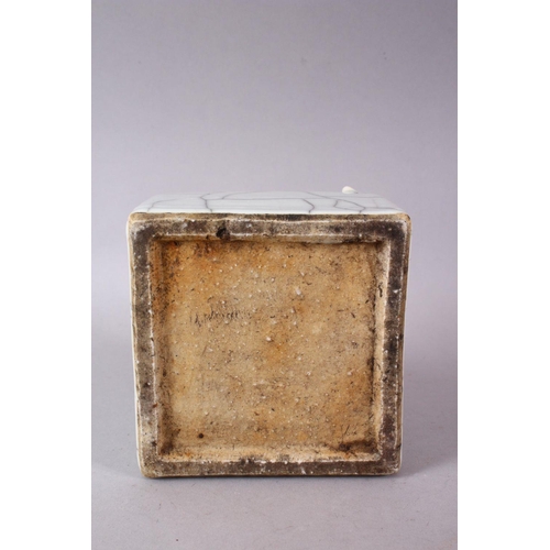 145 - A CHINESE CRACKLE GLAZE SQUARE FORM BRUSH POT, with moulded with chilong, 12cm wide.