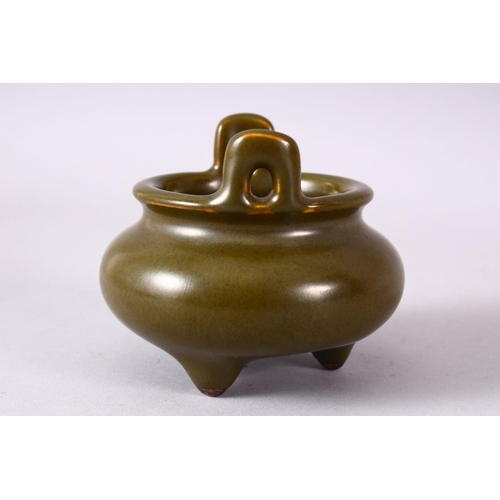 148 - A CHINESE SMALL TEA GLAZE TWIN HANDLED CENSER, impressed mark to base, 8.5cm diameter.