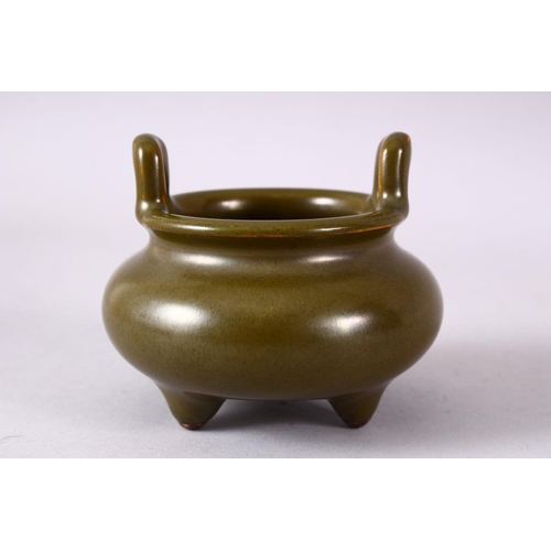 148 - A CHINESE SMALL TEA GLAZE TWIN HANDLED CENSER, impressed mark to base, 8.5cm diameter.