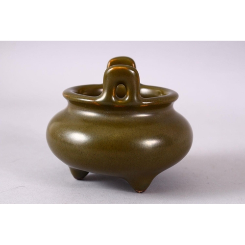 148 - A CHINESE SMALL TEA GLAZE TWIN HANDLED CENSER, impressed mark to base, 8.5cm diameter.