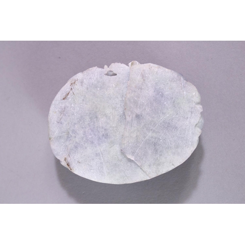 15 - A CHINESE CARVED HARDSTONE  ROUNDEL, carved with kylin and naturalistic forms, 8cm x 6cm.