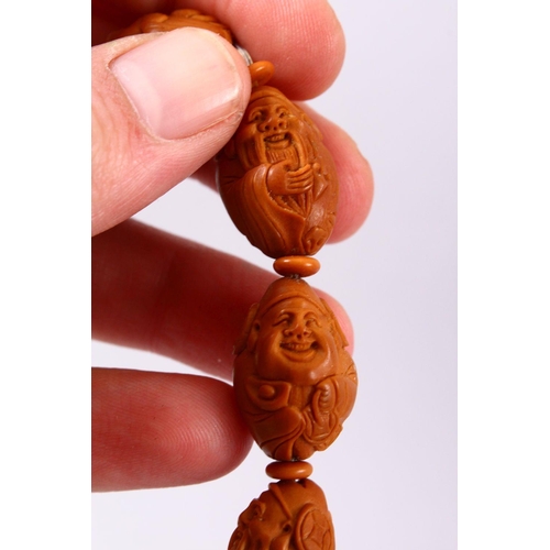 150 - A CHINESE CARVED NUT BRACELET.